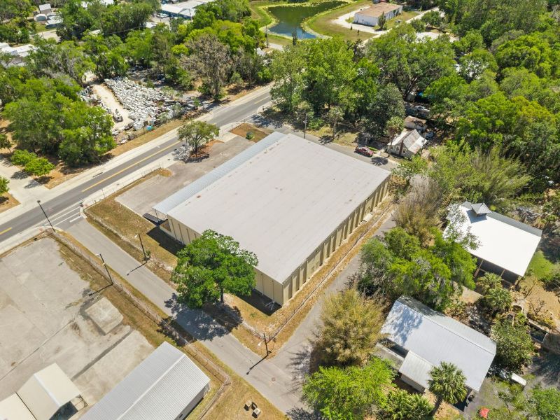 Aerial view of the 18,670 SF concrete block warehouse at 1030 SE 4th Street, Gainesville, FL, showing the roof and fenced lot