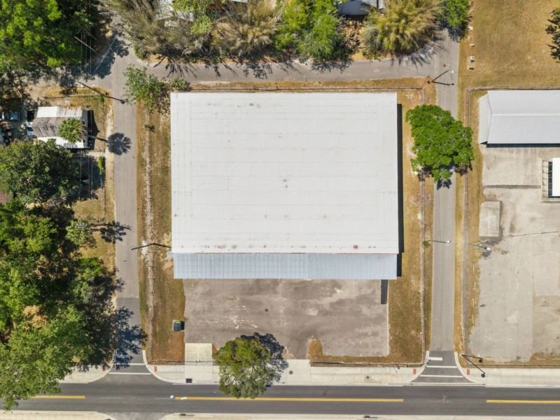 Straight-down aerial of the 0.92-acre site at 1030 SE 4th Street showing the roof, covered dock canopy, yard, and street frontage