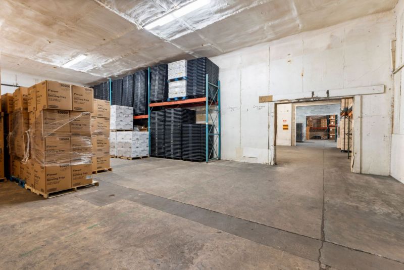 Storage area at 1030 SE 4th Street with a pass-through doorway into the main concrete block warehouse