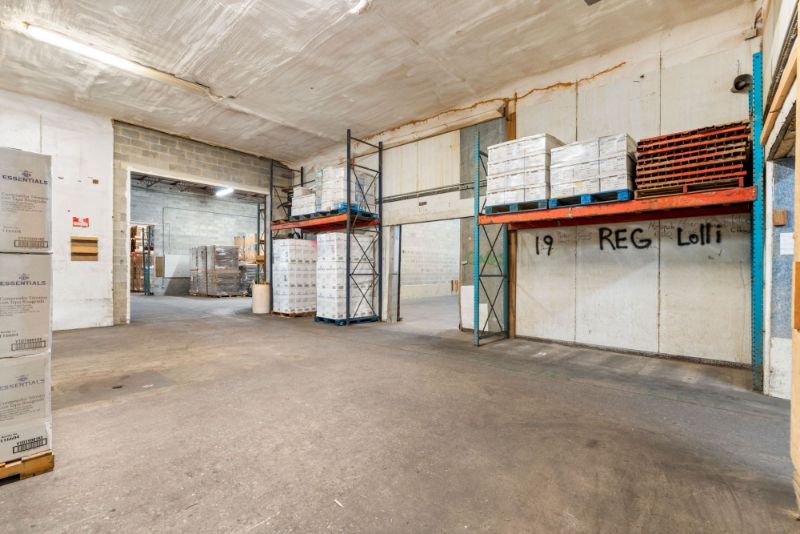 Storage room at 1030 SE 4th Street with an opening onto the main warehouse floor